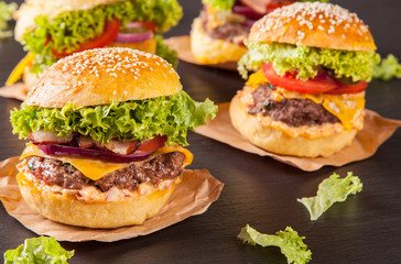 Fresh hamburgers served on black stone