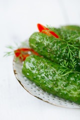 freshly-salted cucumbers on vintage enamel sieve