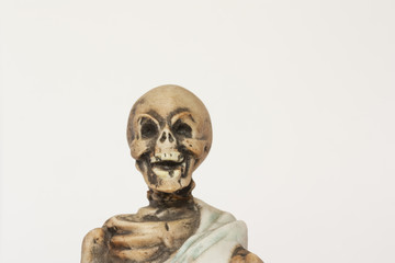 Fototapeta na wymiar Skeleton figurine wearing blue shroud