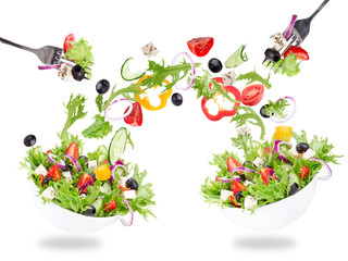 Fresh salad with flying vegetables ingredients