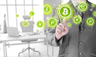 Choosing bitcoins, businessman pressing touch screen button.