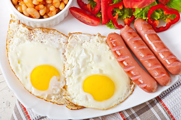 English breakfast - sausages, eggs, beans and salad