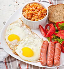 English breakfast - sausages, eggs, beans and salad