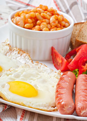 English breakfast - sausages, eggs, beans and salad