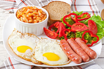 English breakfast - sausages, eggs, beans and salad