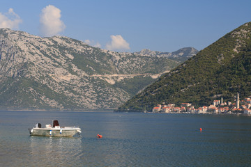 Morning in the Bay of Kotor in Montenegro. White boat