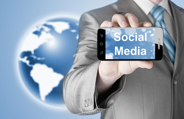 business man hand holding smartphone with Socail Media