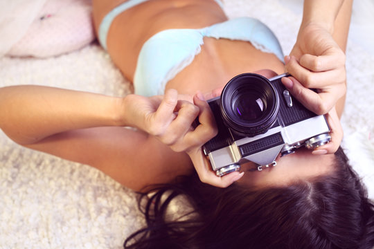 girl in lingerie takes pictures old camera