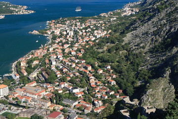 Naklejka premium The town of Kotor, surrounded by mountains and the sea bay.