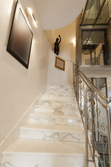 Interior of hotel with marble staircase and banisters