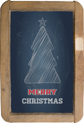 Christmas greeting, little blackboard and chalk on black backgro