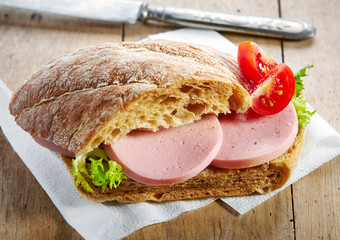 sandwich with sausage and tomato