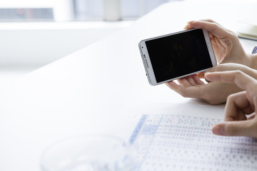 I check the screen of the mobile phone while at work