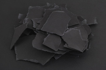 Torn pieces of black paper