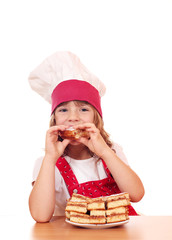 hungry little girl cook eating apple cake