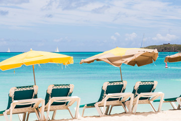Sun Umbrellas Over Green Chairs on Beach