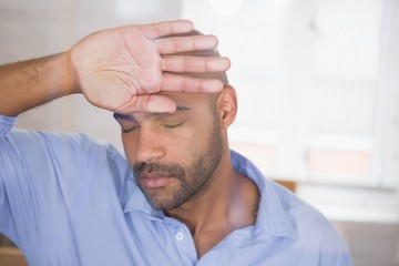 Worried businessman with eyes closed