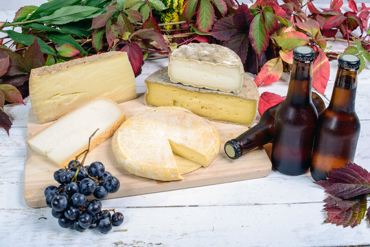 different French cheeses with a few bottles of beer