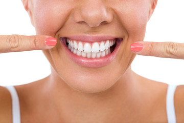Woman showing her white teeth.