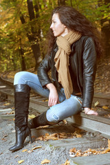 Beautiful girl sitting on the rails