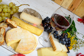 different Savoie cheeses with a glass of red wine