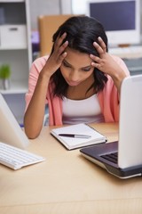 Anxious businesswoman sitting at her desk