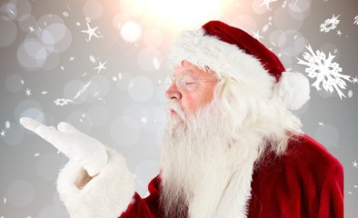 Composite image of santa claus blowing