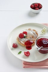 Delicious homemade pancakes with raspberry and jam
