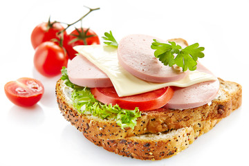 breakfast sandwich with sliced sausage and tomato