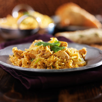 chicken biryani on metal plate close up