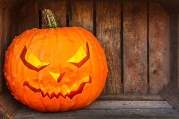 Halloween pumpkin inside an old wooden crate