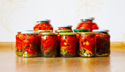 some glass jars with marinated tomatoes homemade