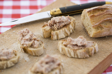 Slice bread with meat pate on wood board