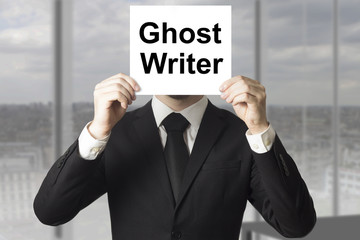 businessman hiding face behind sign ghost writer