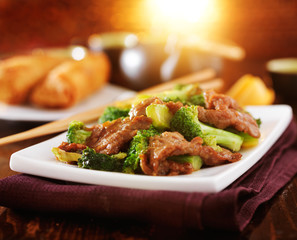 chinese beef and broccoli  stir fry in warm light