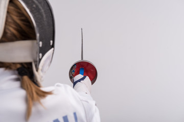 Young woman engaging in fencing