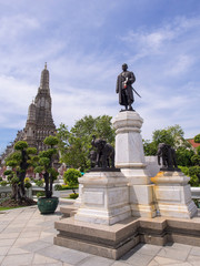 Dawn temple, landmark of Bangkok under cloudy blue sky