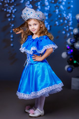 Obraz na płótnie Canvas little girl in suit Snow Maiden near the Christmas tree