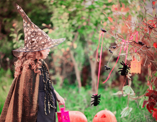 little girl in halloween costume with jack pumpkin