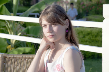 outside portrait of beautiful happy girl sitting at the park caf