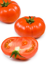 three ripe tomatoes on white background