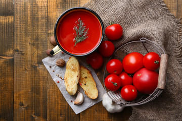 Homemade tomato juice in color mug, toasts and fresh tomatoes