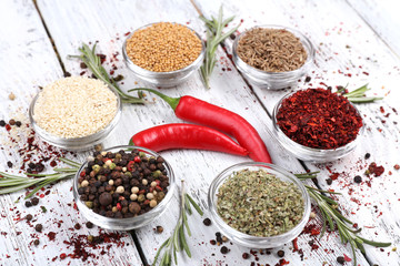 Spices in glass round bowls with herbs and chilly pepper