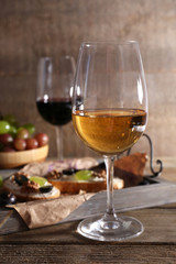 beautiful still life with wine, cheese and ripe grape