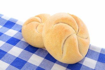 bread rolls on checkered napkin