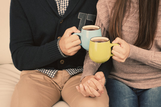 Young couple drinking tea, close-up