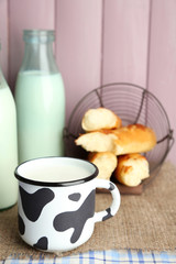 Retro still life with tasty rustic milk, on table