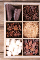 Wooden box with set of coffee and cocoa beans, sugar cubes,
