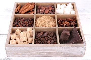 Wooden box with set of coffee and cocoa beans, sugar cubes,