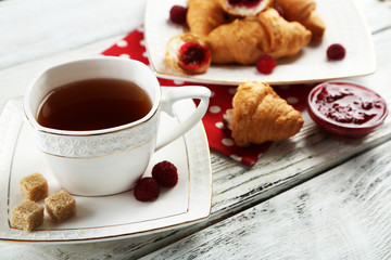 Breakfast with tea, jam and fresh croissants